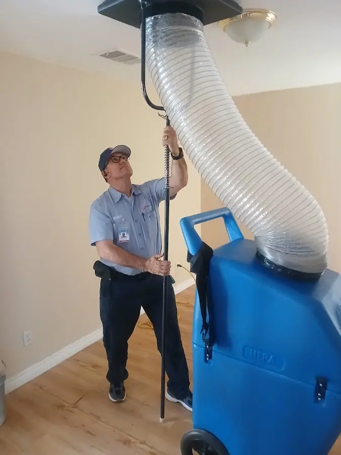 Furnace Tune-Up technician using HEPA equipment in Rosenberg